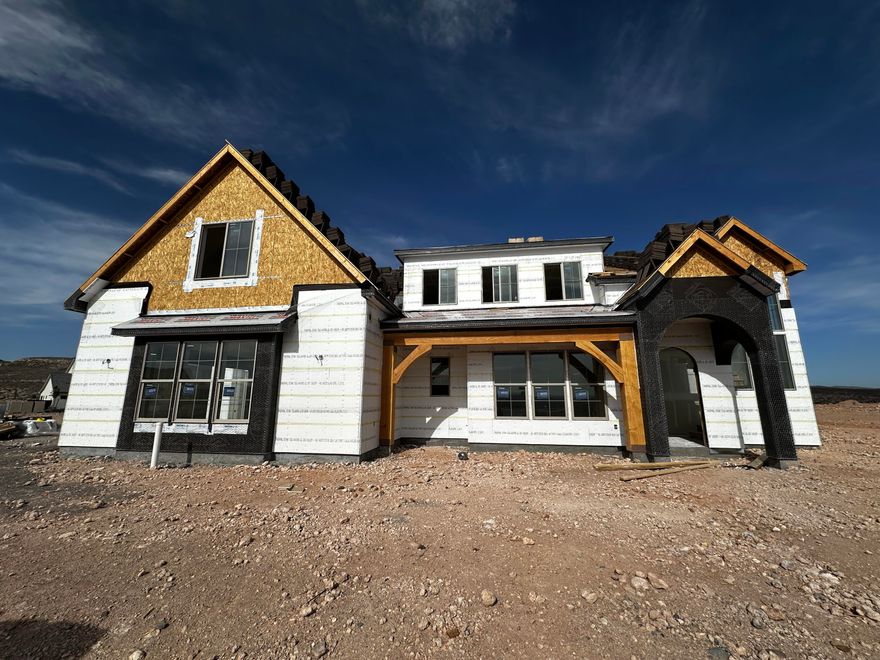 This custom-built home blends timeless traditional design with exceptional garage space and thoughtful construction rarely found in today's market. 50-ft RV garage, 20' wide and 14' garage door. Quality 2x6 construction with tankless water heater and timeless traditional architecture. Vaulted ceilings, hardwood flooring, gas fireplace, quartz countertops, 48-inch range, and panel-ready appliances. Functional layout with 4 bedrooms, 3.5 baths, and Jack-and-Jill bathroom upstairs. Check out the east facing Zion views. The oversized garage includes dedicated workshop space and plumbing for a mini-split system, ideal for a climate-controlled shop or hobby space. Charming front porch and room to add a pool complete this exceptional Southern Utah property. Completion date August 2026.