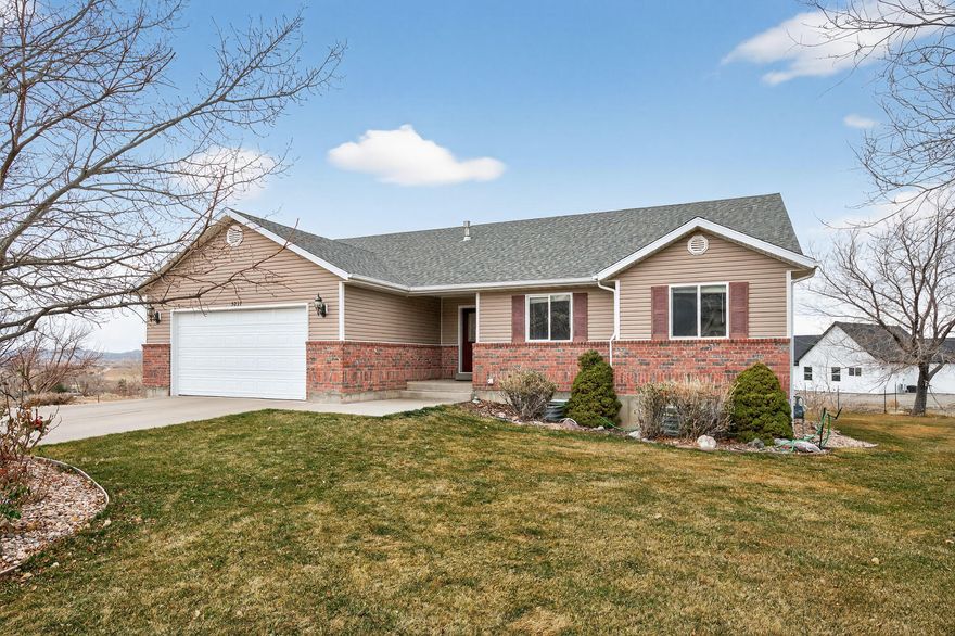 Don't miss this home on a large .47 acre lot in one of Enoch's custom neighborhoods! Nestled on a peaceful cul-de-sac, this beautiful 5-bedroom, 3 bath home boasts a south-facing driveway for effortless winters. Step onto the covered back deck and soak in the stunning views! The fully landscaped yard is complete with mature fruit trees, a generous garden spot, a fire pit and automatic sprinklers for easy maintenance. Inside, vaulted ceilings create an open, light-filled atmosphere. The finished basement offers flexible living space and tons of storage. The basement includes 2 bedrooms and an extra room that would be perfect as an office or den. Additional features include an insulated garage and doors for energy savings and a new roof that was installed in 2022.