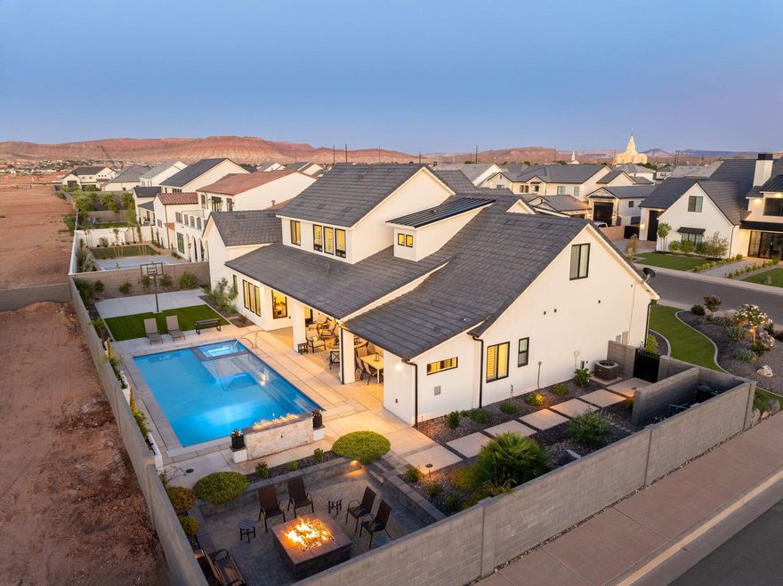 Discover a rare gem in the sought-after Moorland Park community. This elegant home offers a dream backyard with a pool & spa, fire pit, lush palms, planter boxes and sport court—all designed for unforgettable memories. Inside, enjoy soaring ceilings, picture windows, a chef's kitchen with high end Z-Line appliances, quartz counters, and a butler's pantry. Three main-level bedrooms plus an office, stunning en suites upstairs, plus a spacious bonus room. Heated & cooled exercise room off the garage, Boat or RV garage, motorized blinds, Low Cost Dixie Power Utilities, Crimson Cliff school boundaries, and NO HOA! Your buyers truly don't want to miss this one of a kind home. Come see it today!