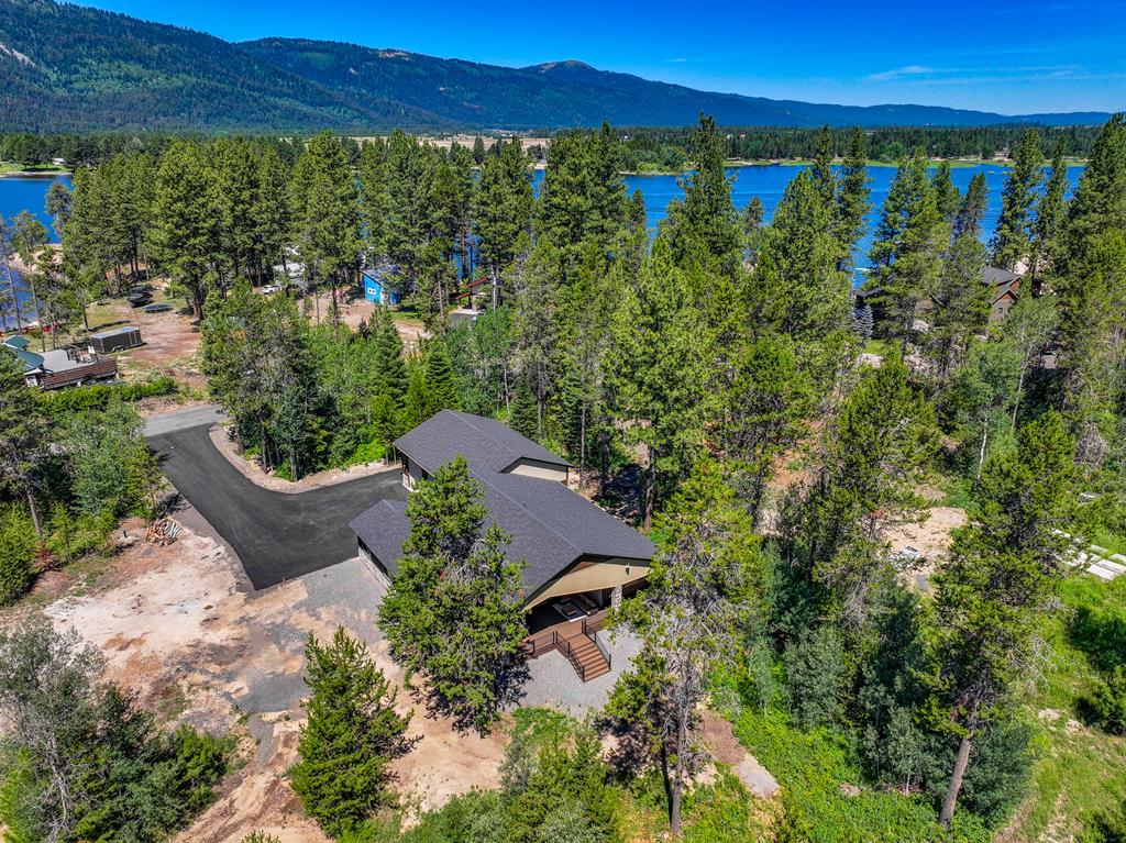 Paved driveway, wooded setting.