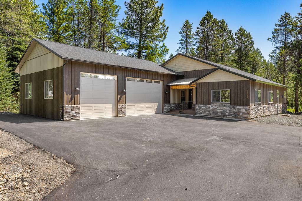 Lovely wooded setting., Plenty of parking in the paved driveway area.