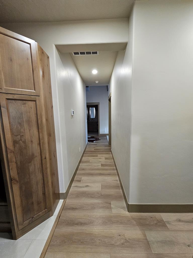 Hallway from garage, Accesses main entry, 5th bedroom/office.