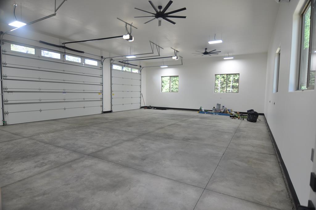 Massive 1600 sq ft garage with 12 by 14 door., Industrial fans move the air.