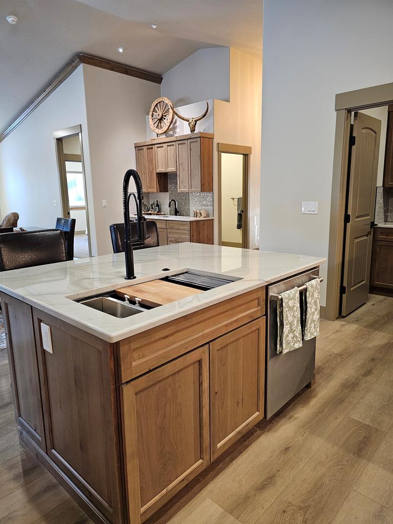 Large island in kitchen., Quartzite countertops. Sink and dishwasher area.