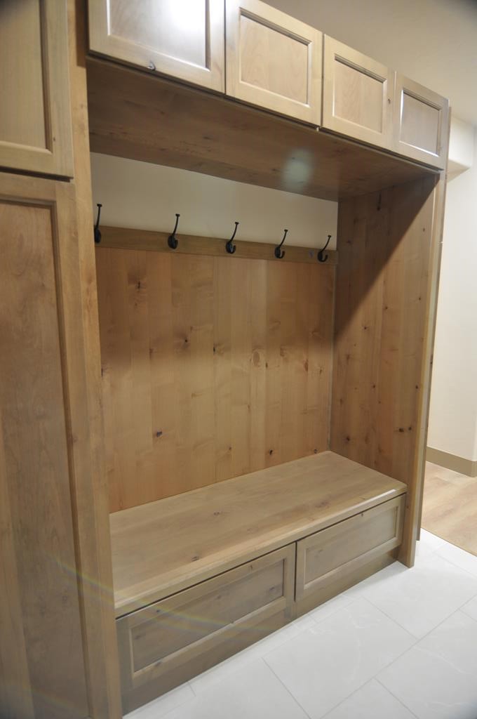 Storage bench in mud room., Laundry/mud room has beautiful storage cabinets, a seating area and bench with even more storage.