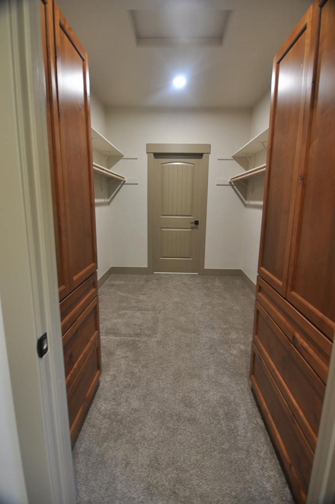 Large walk in closet in primary., Door at other end opens into laundry room.