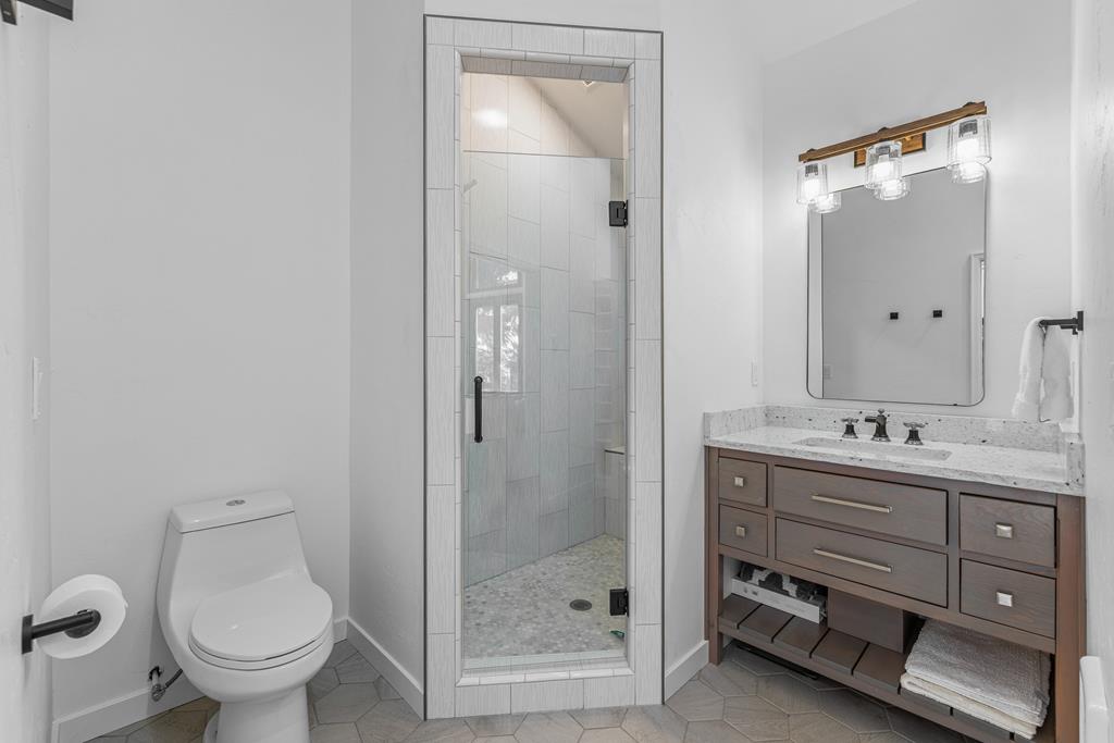 Primary bathroom., Wood cabinet and walk in shower.