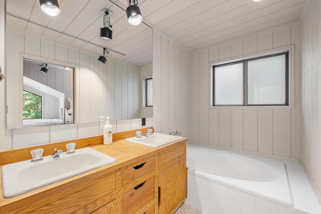 One bunkhouse bathroom., Dual vanities, large soaker tub in the first bathroom.