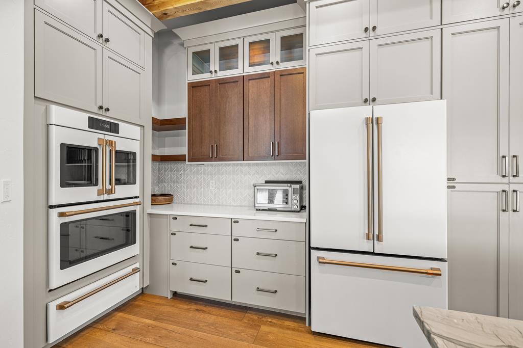 Cafe brand appliances, A convection oven, second oven and warming tray with a french door refrigerator.