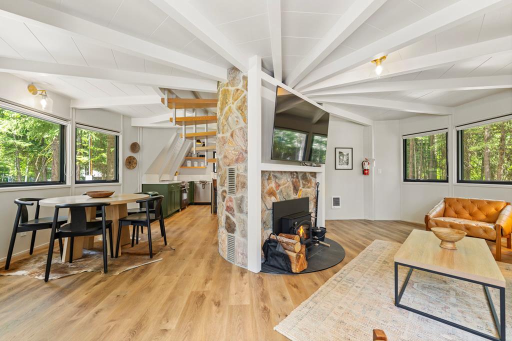 Great Room, Newly remodeled, the great room is open with plenty of natural light and centered around the stone fireplace.