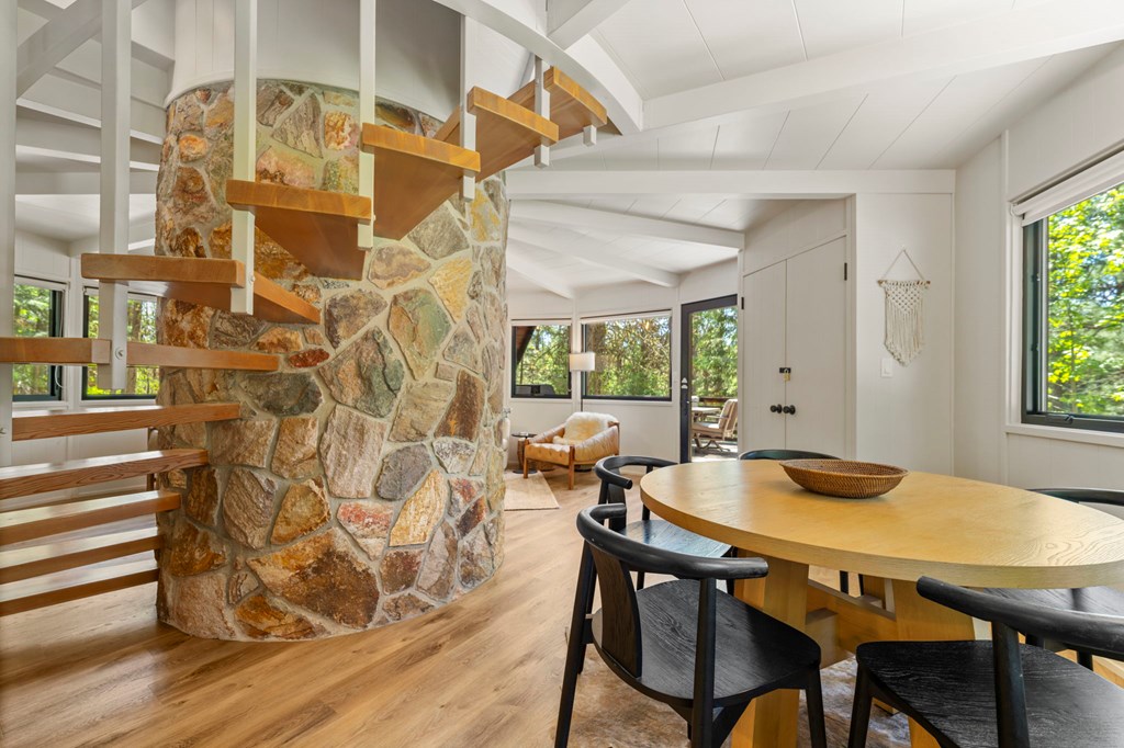 The spiral staircase, The open spiral staircase wraps around the the stone fireplace leading to the two bedrooms.