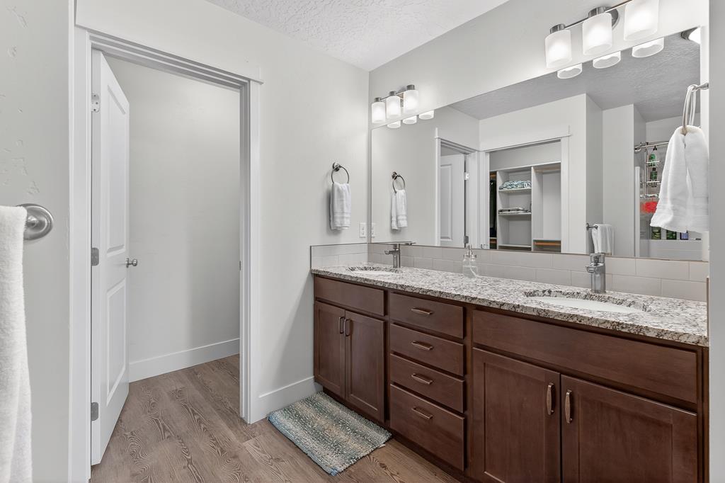 Primary bathroom with dual vanities.
