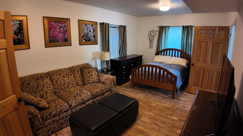 bedroom with 1/2 bath and laundry attached