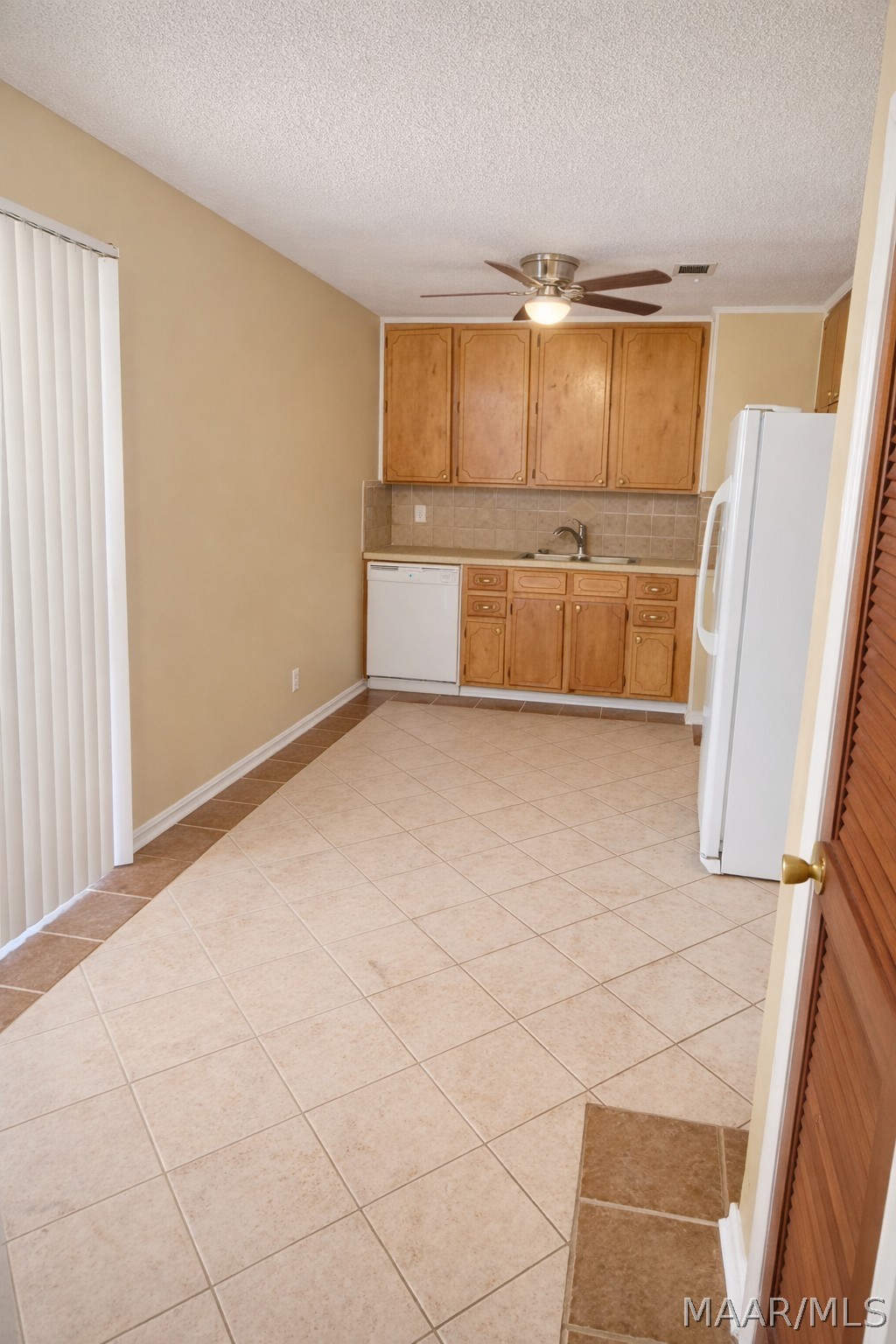 Kitchen with ample storage and easy flow into adja