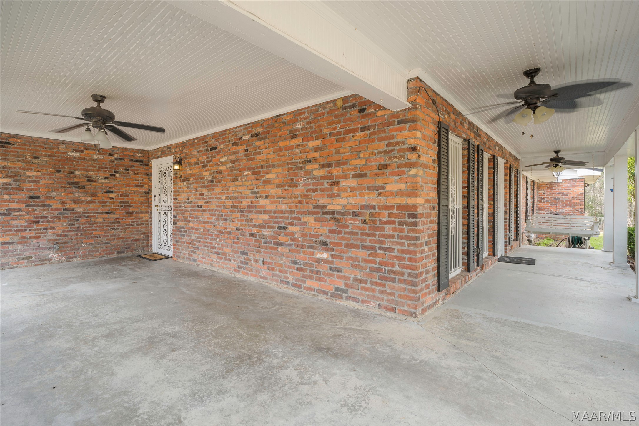 Covered carport and front porch with ceiling fans