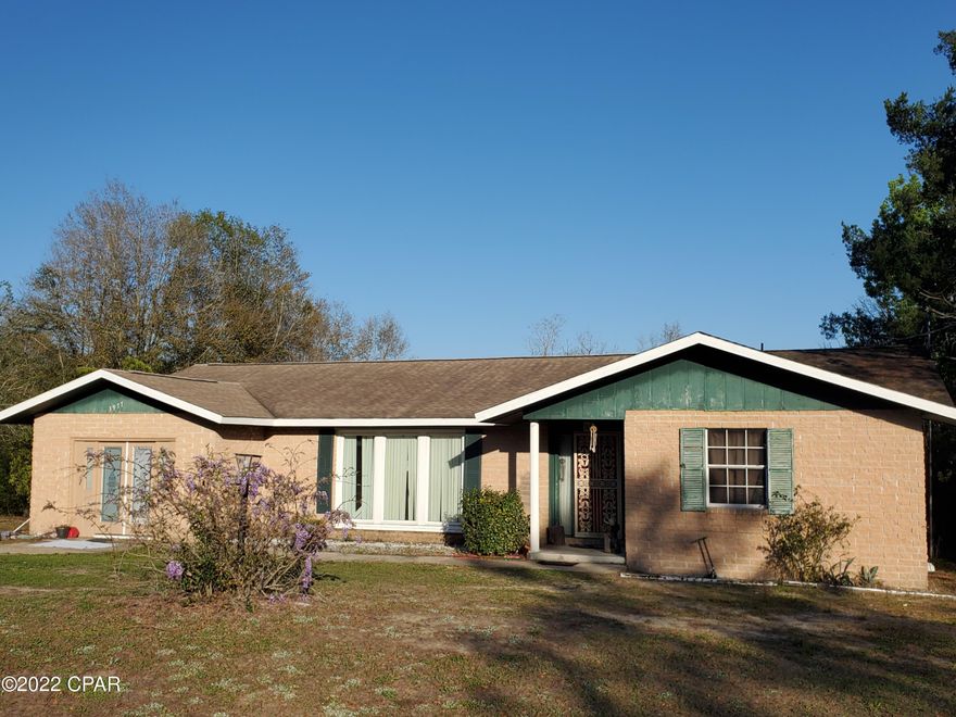 LARGE PRIVATE BRICK HOME IN SUNNY HILLS on over *ONE* ACRE! includes 2 adj. lots to the left, facing the front of the house. Just feet off the blvd. Not a neighbor to be seen. Garage converted to 4th bdrm. could be a MIL suite. Large walk-in pantry. NEW water heater. Covered back porch & hot tub. Washer & Dryer. 2 refrigerators. Big fenced area in back yard. Come in and make this home your own. Near I-10, Chipley, airport, LH, PC, PCB, Pier Park, our gorgeous emerald green Gulf & white-sand beaches, not to mention all the fun recreational springs. Don't forget popular Boat Lk. Rec. & Swim Park right here in SH! Call for your showing & bring your creative vision!