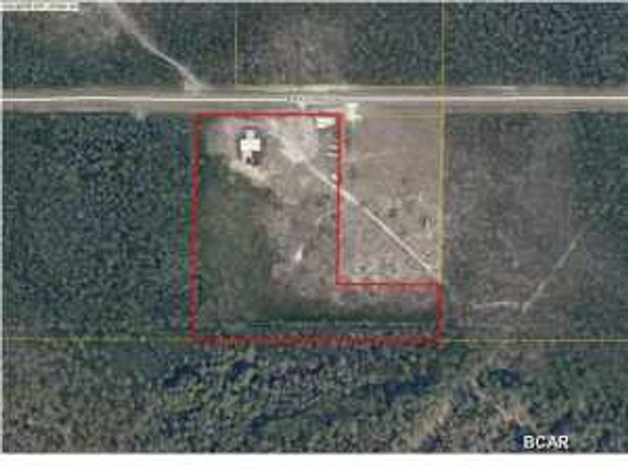 10 acre parcel zoned commercial/industrial located in close proximity to several county establishments. Small office on site, several large covered structures for commercial equipment or machinery.