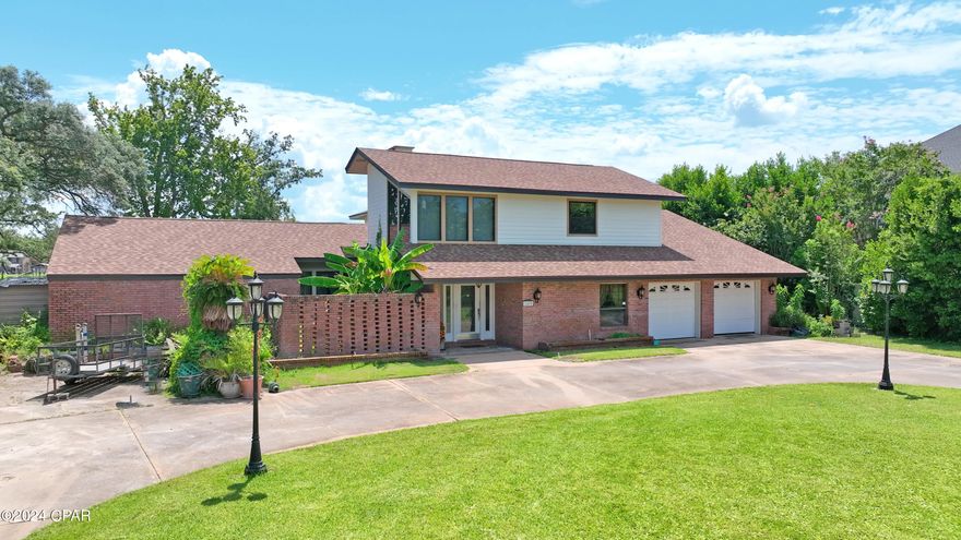 ***CURRENTLY UNDER CONTRACT, SELLER WILL CONSIDER BACKUP OFFERS*** Beautiful contemporary designed home situated on Posten Bayou. next to FSU campus and near all downtown destinations. The highest lot in the subdivision. No flood insurance required. Beloved family home since 1977. Upstairs feature 2 bedrooms, bath with double vanity, small  kitchen area, and large lounge area for pool table or couchs for relaxation media area. Beautiful hickory flooring in this area. Downstairs needs TLC. Original appliances, cabinets and windows. Home features roof installed in 2019, windows upstairs installed in 2022, hardiboard siding upstairs , aluminum trim and painted in 2023. New 5 ton hvac installed 6/24.  110' seawall installed in 2023 along with new dock. Walls are constructed with 2 x 6 framing. Fireplace is decorated with rose quartz. Boat lift held up to a 23 ft. boat. Bayou is deep water year round and direct access to North Bay. Upstairs needs updating cosmetically......downstairs needs remodeling with ceiling sheetrock to be removed to replace a/c ducts due to sweating. Kitchen works but updating would increase enjoyment. Listing agent and co-owner is LICENSED Florida Realtor.