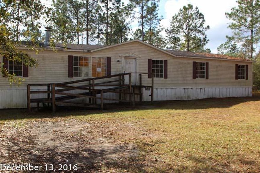 Country location with half acre +/- lot with a double wide mobile home.  Home has 5 bedrooms, 3 baths with an eat-in kitchen.  Home is a foreclosure and will need work. Property being sold, AS IS, where is.