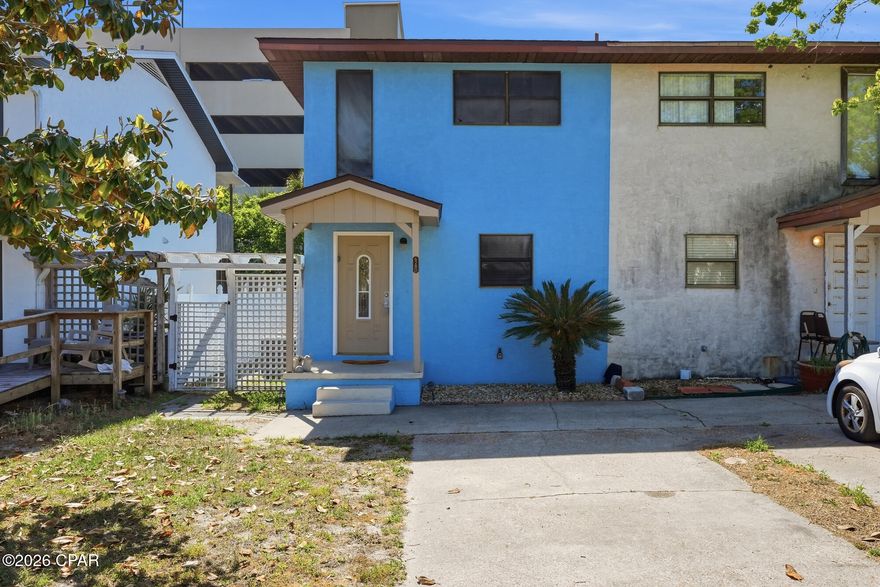 This 2 bedroom 1 ½ bath townhome is a short walk to the world's most beautiful beaches via beach access 51. There is no HOA! This townhome can be used as a residential home, second home or short-term rental. Downstairs there is a living room, kitchen and dining area. The half bath is easily accessible for guests and there is a full-size washer and dryer in the laundry area.  Walk outside to the nice size fenced in backyard with covered porch and an owner's closet. Upstairs there is a larger bedroom with an upstairs balcony and an additional bedroom. The bedrooms share a full bath that can be accessed from the hallway. This townhome on Caladium circle is walking distance to multiple restaurants including Runaway Island and Steamer Seafood Market. Live the beach life at an affordable price with this townhome that has lots of potential!