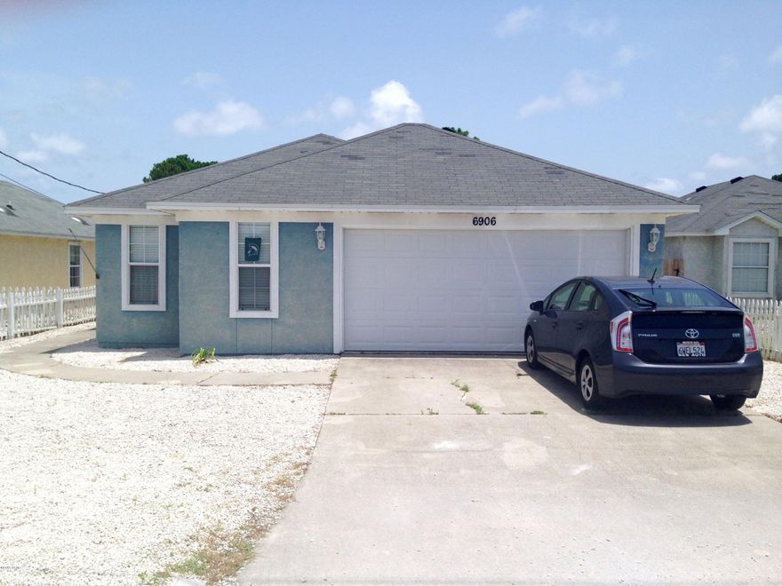 BEACH HOUSE - WALKING DISTANCE TO GULF AND LAGOON!  This home features 3 bedrooms, 2 bathrooms, an open floor plan with split bedrooms, tile flooring throughout (easy maintenance), a high Living Room ceiling with planter shelf, a functional kitchen with breakfast bar, a 2 car garage, a covered 10x10 patio, and an easy maintenance yard (all rocks) surrounded by a white picket fence.  This home has so many possibilities!  Permanent residence, 2nd home, or vacation rental!  Call today for your own private preview.  All measurements approximate; buyer to verify if important.