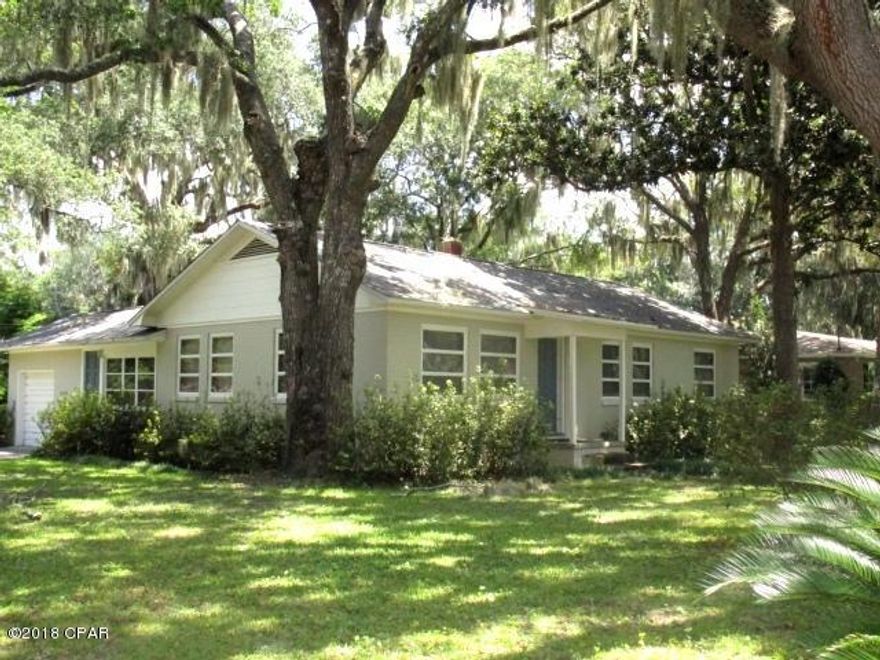 LOCATION, LOCATION!  Situated on a corner lot and just past amazing waterfront homes sits this all-brick home that features a spacious living room, updated kitchen with tiled counters, a Master bedroom with a large double closet with added shelves, two additional bedrooms and hardwood floors throughout the entire home.  The one bath has a pedestal sink and a tub/shower combination.  Outside the bath area is a built-in china-style cabinet as well as a linen/storage cabinet.  Off the kitchen is a den with ceramic tile floors and easy access to the backyard and one-car garage.  The fenced yard has a patio area surrounded by a beautiful tree-filled yard, and the roof is only 5 years old!  This home is in immaculate condition and a MUST SEE in this price range!