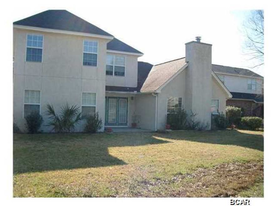 Brick and stucco home located on the 5th green of Panama Country Club which offers private championship golf, bay front clubhouse, and pool...Interior of home offers tiled living room with fireplace, formal dining room with laminate wood flooring, kitchen with custom cabinets and gas stove, breakfast room, downstairs master bedroom, half bath, and three bedrooms (one bedroom would make great play room/media room, it measures and one bath upstairs...Exterior offers side entrance two car garage, open patio, large oak tree, sprinkler system, and great views of the course... All sizes are approximate, please measure and verify if important. School assignments are subject to change, please check with Bay County for most accurate information. Pets allowed with owner approval and NON