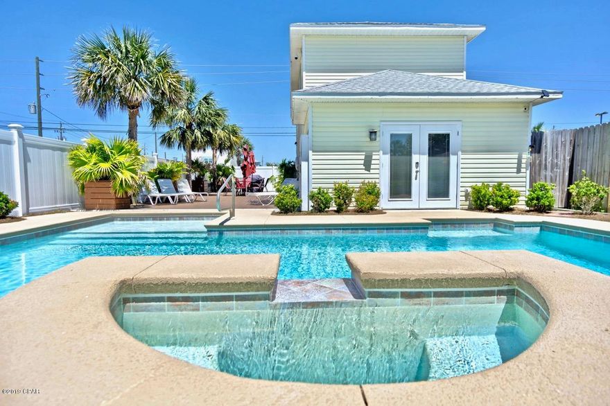 RENTAL MACHINE- YTD: $112,604.89 and growing!  Amazing Opportunity to own a 4 bedrooms, 3 full baths, SALTWATER HEATED POOL home PLUS a 50x105 Vacant Lot, all within walking distance to the Gulf-Of-Mexico!  This home features a new roof, 10 ft. ceilings, and a wide open living area with a fabulous floor plan.  There is a master bedroom on the 1st floor with French doors leading to the pool area.  The kitchen features stainless steel appliances, granite countertops, and there is a custom-made kitchen table which overlooks the stunning deck and grilling area.  The 2nd floor hosts an additional master suite with a private bath, and a private balcony, and there are two additional bedrooms, one of which features double bunks, with bedding for four,   (Enter on MORE)the other with a queen size bed, and another full bath upstairs.  This home has plenty of room for all and makes a fabulous rental.  If you like to entertain or enjoy the outside this is the home for you.  The amenities add a special touch, making this beach house a luxury home.  The private saltwater, heated pool with a hot tub and waterfall will leave you feeling like you are on vacation all day.  The pool is surrounded by a Trex built-in sundeck, with 1400 Sq.Ft. of decking, and tables with seating for 10, 6 tanning lounge chairs, a grilling area, multiple decorative planters, storage containers for all your beach toys, and beautiful landscaping.  There is also a well which feed the irrigation.  Best of all, this outside entertaining area and pool were all just installed under 3 years ago, with the fence, planters, tables/umbrellas all being new in 2018-2019! There is also a back exit, from the pool area, which leads to an easement with quick access to Holiday Drive, which is a 1-2-minute walk to beach access 13 and the beautiful white powdery sand and emerald water! If that is not enough, there is a separately parceled 50x105 vacant lot included in the sale which sits to the immediate right of the home.  Live in your dream home while you build another home, store you boat or park your RV, or just hang on to the lot for a future investment.  There is so much we can say about this home but you must view it in person to take in all its beauty.  Additional items include: New auto pool fill and new salt cell, new Arlo-4 camera Smart System, some new siding, lift station had a new lift installed in 2019 and electric pump in 2018, new interior paint throughout, new living room sofa, new ceiling fans, new garbage disposal, and plenty or storage and owner locked closets.  In addition, this home is setup as a "smart home" where the heating, air conditioning, security system, hot tub, pool heat, surveillance camera, door locks all can be controlled remotely from your phone.  If this sounds like the home you have been looking for contact your Realtor today for a private showing!  Age, Sq.Ft., Room dimensions, taxes, schools, or any important information to a buyer must be verified via personal or professional inspection.