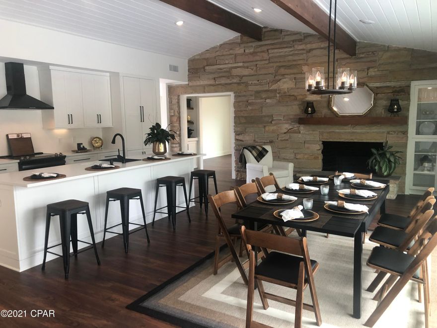 This beautiful 4 bedroom 2 1/2 bath home sits on a 1/2 acre water front lot. It includes many custom features such as high ceilings with tongue and groove, foam insulation in entire ceilings, custom cabinetry, beautiful landscaping, two fireplaces and an outdoor fireplace to enjoy the large courtyard. Everything new: roof, 2 high efficiency  HVAC, plumbing, electrical , flooring, doors and windows. This home is turn key ready to move in.