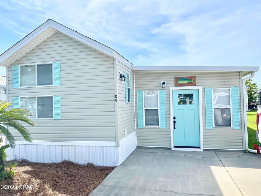 CURRENTLY UNDER CONTRACT, SELLER WILL CONSIDER BACKUP OFFERS - This beautifully updated beach bungalow located in Emerald Pointe Resort is perfect for a part-time/full-time residence or investment property. This home features 2 bedrooms, 2 full baths, a 12x12 screened in patio, nice size add on living room with a breakfast bar over-looking it, and a separate 10x12 storage building with electricity for added storage. There is room to add on to the home and the owner has drafted preliminary plans which are available upon request. The home has had many updates since 2019 which include: AC unit in 2021, architectural shingle roof with ridge vent on Park Model and 10x12 storage building in 2021, microwave 2022, LVP Flooring throughout, interior paint and many more.  Ask your realtor for the complete list. The home is located on the Palm Tree road, which adds to its drive up appeal, and is centrally located between the clubhouse, both community pools and the dog walking areas.
Emerald Pointe Resort is a gated community located in the heart of Panama City Beach close to restaurants, shopping, and the world's most beautiful beaches. Amenities include a large clubhouse, exercise room, shared library, 2 pools (one heated seasonally), hot tub, lake with boardwalk, and shuffleboard court. HOA fee includes water, sewer, garbage, cable, and lawn service. All information is approximate and should be verified by buyer if important.