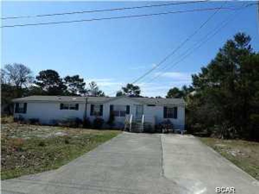 Large 4 bedroom 2 bath home on a huge double lot with 158'street frontage and 150'deep. Not only does this large home on the west end of Panama City Beach have 4 bedrooms, but there is a large room off of the master bedroom that could be used as an office, library or whatever you would want. There is also a large workshop or storage building on the lot next door that is included in the price. Relax on the large wooden deck in the backyard. Add another 79'frontage and 150'depth by purchasing the 3rd adjacent lot! MLS #630100.
