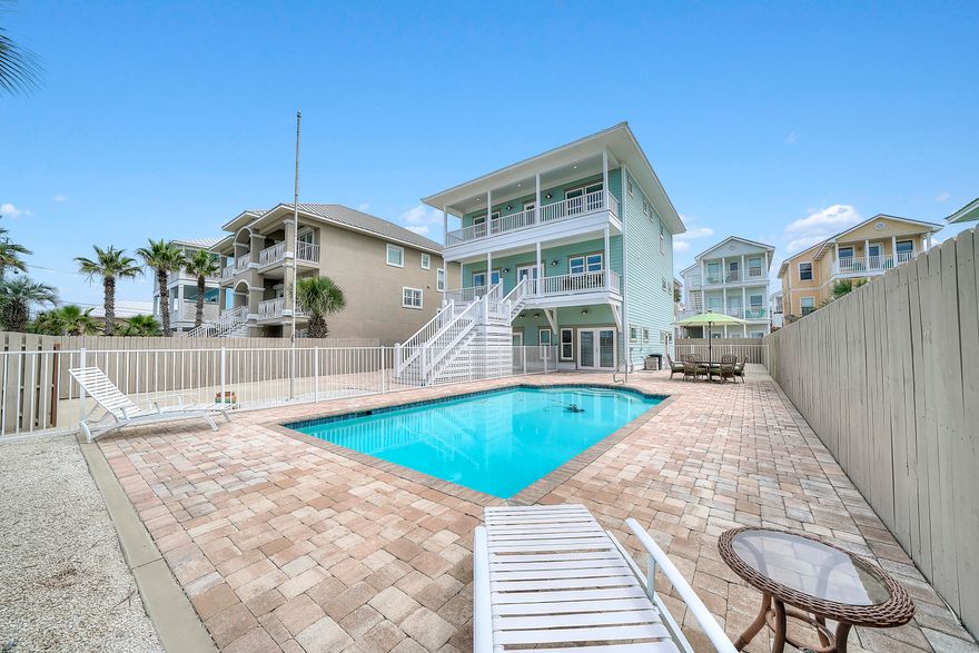 Custom, one-of-a-kind, stunning, exemplary construction quality, modern luxury --- just a few words to describe this multi-level FULLY FURNISHED home with Gulf views. This exquisite beach home offers high-end luxury with amenities to include a private pool with gas heater, gas log firepit, 6 ft privacy fence around the entire property with maintenance free outdoor space (no lawn). The interior of this well-designed open concept layout offers five-bedroom suites each with its own full bathroom and a half bathroom on the 2nd floor off the main living area. The second level has a gourmet kitchen outfitted with GE Café model stainless steel appliances, beverage and wine coolers built into the oversized kitchen island and custom built soft close cabinets. The kitchen is open to the expansive living room, dining room and relaxation area. Top of the line stranded bamboo floors, gorgeous granite counter tops, 9 foot ceilings, gulf front porches off the 2nd and 3rd floors, Rinnai on-demand hot water heater and 3 commercial grade Daikin HVAC systems with humidity control are a few of the upgraded features you will find at this beautiful beach home. There is a finished garage and a FULL 2nd KITCHEN on the 1st floor with KitchenAid icemaker, gas range, microwave and plenty of space for prep and cooking. Master bedroom is located on the 1st floor with French doors leading out to the pool and fire pit. 1st floor could be a mother-in-law suite and there is a 6th FULL bathroom conveniently located on the 1st floor off the pool area for guests. Additional features include, high end Shwinco brand windows and doors and this house has been built to withstand a category 5 or higher hurricane, with a heavy gauge aluminum standing seam roof. You know instantly when you enter this home, it is quality built. So many upgrades  ask your Realtor for the print-out of the Features List and come see this exceptional home today!