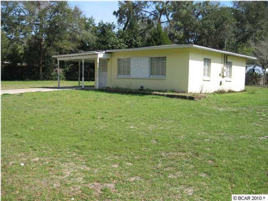 In 'tip top' shape! You'll find a newly renovated house with new floors (laminated hardwood), new stove, new bathroom, and recently repainted. There are hurricane shutters for all windows & wired for a security system. House is located on one of the largest lots in the area and centrally located. It is a block house that's solid. In the rear of the property is a 12 x 12 workshop with electricity and on a concrete slab. This would make a great starter home or investment property. House being sold AS IS. It's move-in ready and CLEAN CLEAN CLEAN!