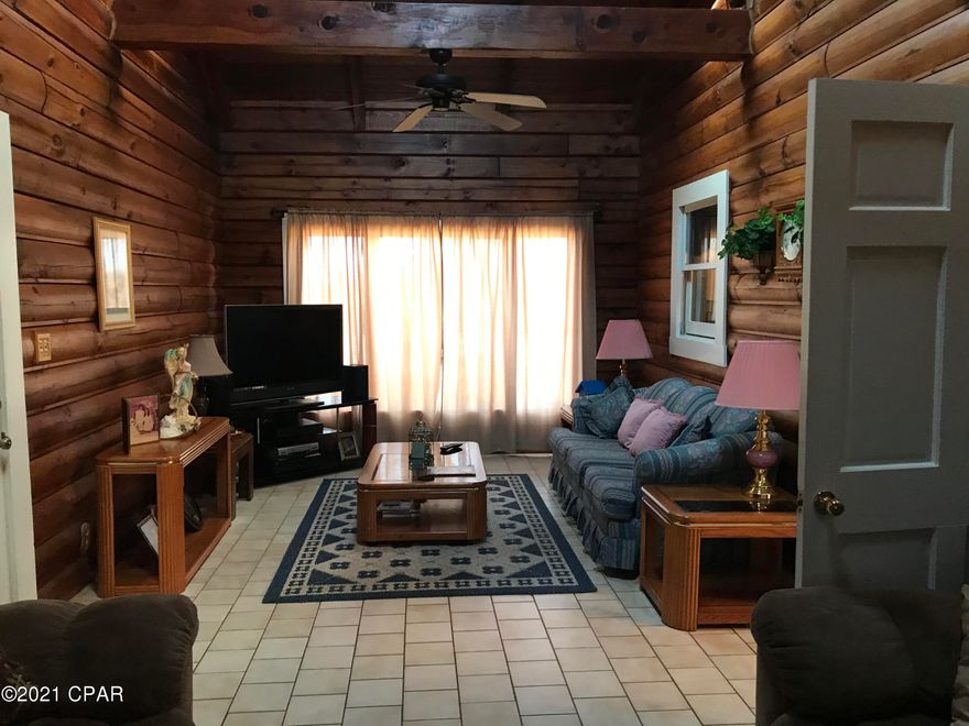 Quiet Country Living At It's Finest.   Peace & Quiet Can Be Found Here In An Abundance.  Absolutely gorgeous 5 bedroom, 2 full bath, 2 half bath Log Home sitting on 10.0 acres more or less.  Over 3,200 heated & cooled sq. ft. of living space.  2 bonus rooms(1 downstairs & 1 upstairs).  Huge eat-in kitchen, large separate dining room with separate family room.  Family Room has massive floor to ceiling stone fireplace & huge wooden beams running across.  Large capacity hot water heater with Turbo Charger Heat Extractor for water saving.   All this comes with a huge inground, screened-in salt water pool just outside the back door & a 48 x 30 ft. pole barn in the yard to hold all your toys & equipment.  All room measurements are approx.  Buyer would need to verify.