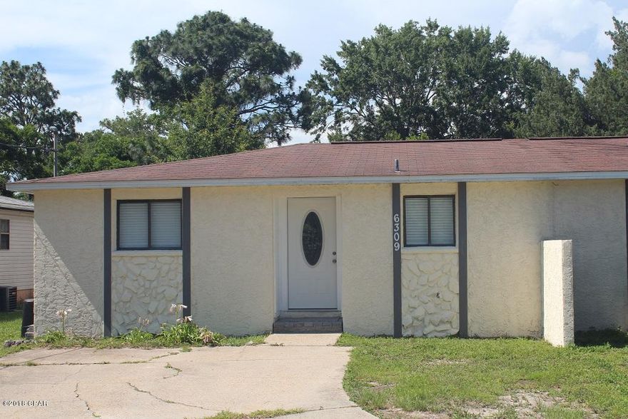 Stunning half duplex close to Tyndall Air Force Base and Eastern Ship Yard.  This home has been completely stripped down and refinished.  The kitchen wall has been removed to create a wonderful great room that is perfect for entertaining.  Many of the upgrades include a brand new kitchen to feature soft close cabinets, kitchen island with cabinets, new counter tops, newer stainless appliances, beautiful back splash and fixtures.  The open living room features recessed lighting, new orange peel textured walls, new vinyl plank flooring through out and double doors that lead to an open back patio.  The bedrooms feature new fixtures, new doors and new carpet.  Both the hall and master baths are completely redone with nice tile showers.  The home has new interior and exterior paint through out. The huge back yard features a new privacy fence along with mature Kumquat and grapefruit trees.  The back patio would be amazing with some exterior entertainment lighting and patio furniture. This home has been tastefully remodeled and will make you feel right at home.  This property would be perfect for your personal home or rental property for your portfolio.