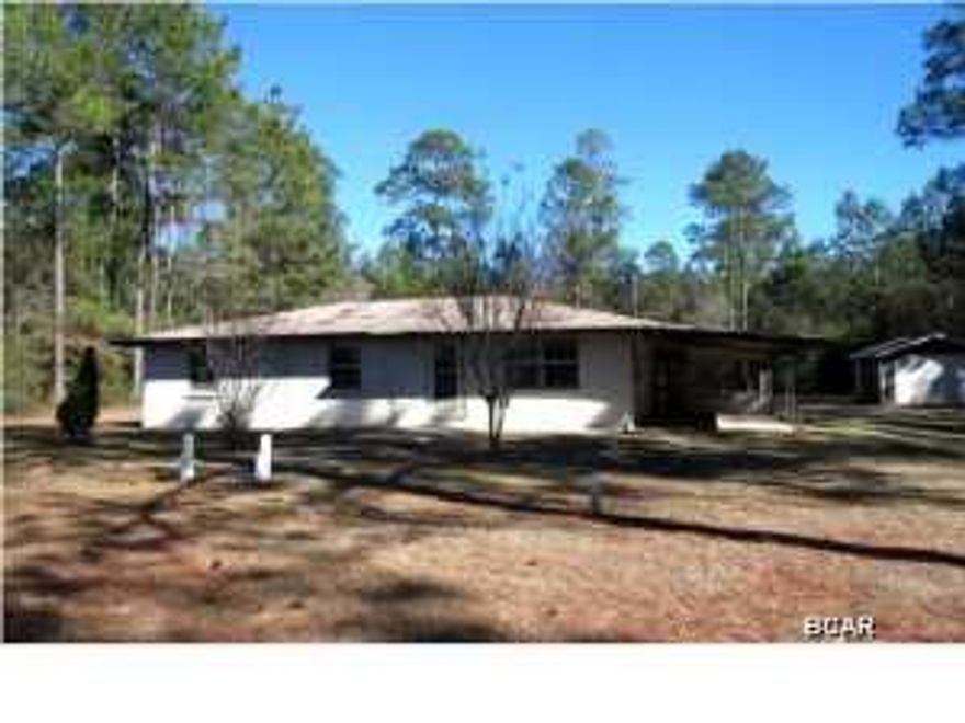 THIS IS TRULY COUNTRY LIVING AT ITS BEST! If you are looking for a little bit of land and a lot of privacy, this is it. The home is situated on a one-acre cleared lot that features a large workshop. The home features a living/dining area combination off of the kitchen, and all of the bedrooms have ceramic tile flooring. The screened porch off of the back of the home overlooks the landscaped yard. This is a perfect find for the first-time homebuyer! Home is being sold in its AS IS condition.
