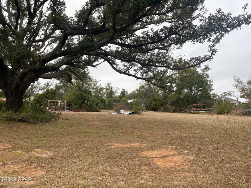 Under Contract - Taking Backups....  Searching for that perfect centrally located property for your next build?  This double lot is located in the heart of St. Andrews and is convenient to restaurants, shopping, and schools.  The magnificent oak tree provides plenty of shade for the hot summer days and the emerald beaches are just a short 10-15 min drive.  No flood insurance required.  Present zoning is MU-2.