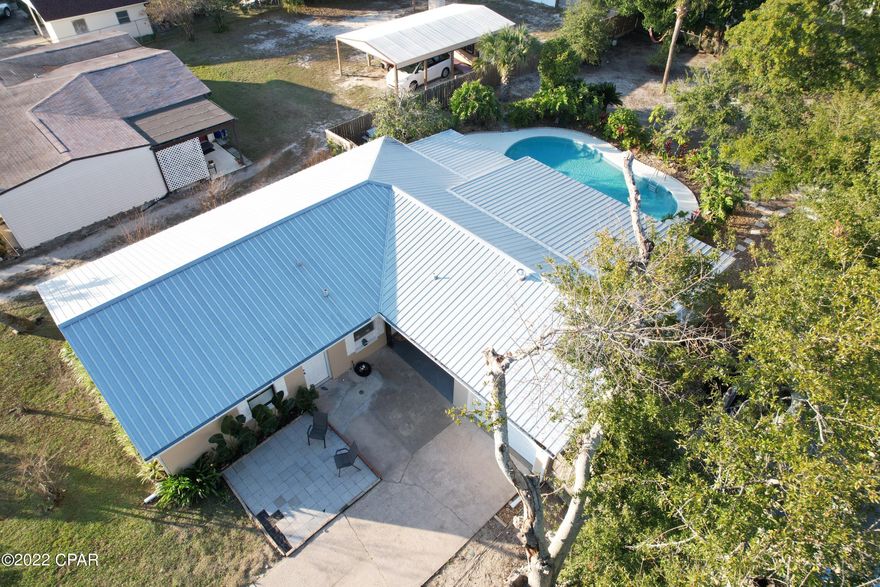 Beautiful newly painted home just four blocks from the water. An oversized back yard and inground pool surrounded by a privacy fence makes this the perfect home for entertaining. Get your vitamin C from your own fruit trees. The home features beautiful hardwood floors, handicap access, and a security alarm system. The triple sliding doors in the kitchen open the wall up to the screened patio by the pool. Schedule your showing today.