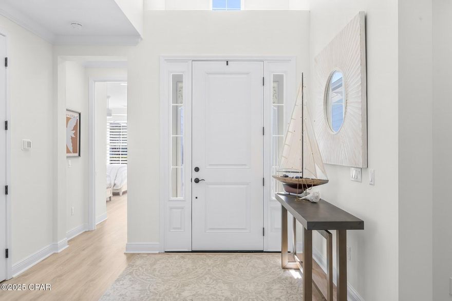 Come see this beautiful home - a one-of-a-kind opportunity in the community of Latitude Margaritaville Watersound!  Rarely on the market and highly desired Aruba model with pond view, screened in pool, spa, and 3 car garage!  This sought-after Aruba floorplan home features 2 bedrooms plus den or 3rd bedroom, 2 and a half baths, gorgeous upgrades and a coveted location on a quiet street with close proximity to amenities.  Open the door and welcome to your private oasis, where no expense has been spared and no detail has been overlooked.  The finishes and upgrades were carefully selected, creating a blend of coastal elegance and comfort throughout the home.  Enjoy upgrades such as stone quartz countertops in every room (even the laundry room and back wall of kitchen), plantation shutters, crown molding, tray ceiling, Laminate Revwood by Mohawk floors throughout, custom crafted wood shelves in the closets, and a massive kitchen island with ample seating.  The kitchen also features upgraded cabinets, pull-out drawers, wine refrigerator, 5 burner gas stove, soft close cabinets and drawers, tons of storage and more.  This laundry room is most popular, and the largest laundry area, set just off the kitchen with cabinets galore and tons of counter space for a coffee station or whatever you desire.  Your screened-in back patio is a wonderful place to lounge or entertain, open your double sliding doors all the way to provide a grand entrance and combine your indoor and outdoor living spaces.  Enjoy your premium pond view, beautiful pool and spa, privacy sun shades and relax in one of your lovely spots for lounging, dining, and conversation.  This exquisite residence is the ideal spot to experience the lifestyle of the Latitude Margaritaville Watersound 55+ community; where comfort, sophistication and fun come together seamlessly.  Enjoy amenities in abundance, including HOA-maintained lawn care, sprinklers, a Town Square, paradise pool with beach entry cabanas, tiki huts, restaurant and bar with panoramic views of the intercoastal waterway, a state-of-the-art fitness center with workout equipment and exercise rooms and 75' lap pool, pickleball and tennis courts, bocce ball courts, kayak launch, dog park, walking trails, golf cart and biking paths, and more!  The community also boasts a bandshell for concerts, and an exciting calendar filled with parties, games and live music.  In addition, a brand new public marina is planned and will include both dry storage and wet slips. The marina will be located on the Intracoastal Waterway with convenient access to West Bay, Choctawhatchee Bay and the Gulf waters.  You are also just minutes to the beaches of Panama City Beach and the popular Pier Park for additional shopping and dining.  Whether you are relaxing or entertaining guests at homes or taking advantage of the many activities and amenities, this is the perfect space to enjoy both tranquility and the excitement of an active community.  Don't miss out on this extraordinary residence and the exceptional community of Latitude Margaritaville Watersound - call today!