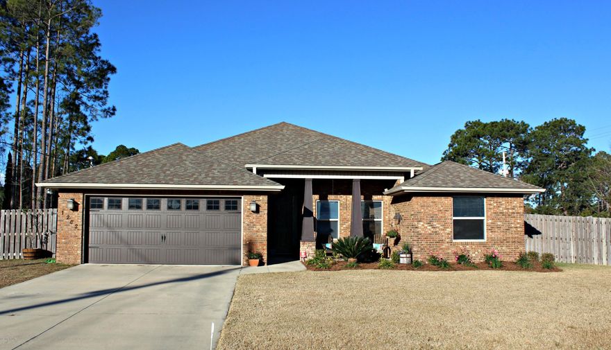 Modern 4 bedroom 2 1/2 bath open floor plan home in desirable Lynn Haven.  This 2011 custom built home is located on a spacious corner lot.  This home showcases gorgeous stained concrete floors in the main living areas and master bedroom and carpet in the additional bedrooms. The kitchen and bathrooms have granite countertops and custom cabinets. Stainless appliances, tiled backsplash, trayed ceilings, custom crown molding and wainscoting are just some of the upgrades. For energy efficiency the front windows have all been UV coated, there is a wood burning fireplace and a sunroom in the back of the house that has a wall of sliding glass doors so you can open this space up fully. The master bathroom has a walk in shower, soaker tub, double sink vanity, and his and hers closets. There is a security system, sprinkler system, termite bond, two car garage and full privacy fence with double gate access to backyard.  You will love this quiet neighborhood known for it's great neighbors, fantastic streets for walking, top rated district schools and friendly neighbors.  It is close to shopping, restaurants, and easy access to main roads for ease to getting to work or school.  Make plans to come view this beautiful home today! [Draperies in living room and kitchen along with baby gate do not convey]
