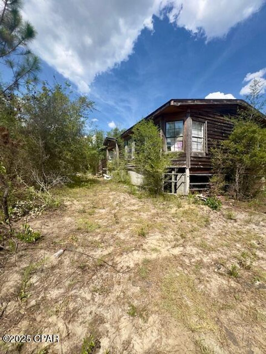 AS-IS, Cash Only!  Investor or Handyman Special!  This double-wide manufactured home sits on 8 acres of land and offers plenty of potential for the right buyer. The property will require a full trash-out and significant renovation, including a new roof, and the septic tank has been damaged. The condition of both the septic and the well are unknown, and all trash, debris, and personal property located on-site are included in the sale. In addition to the home, the property also features a damaged metal outbuilding with a concrete foundation and a boat that will convey. Adding to its appeal, Buckhorn Creek runs along the back side of the property, offering a natural water feature and peaceful setting. With its acreage and peaceful setting, this property provides an opportunity to restore, rebuild, or start fresh with your own vision.