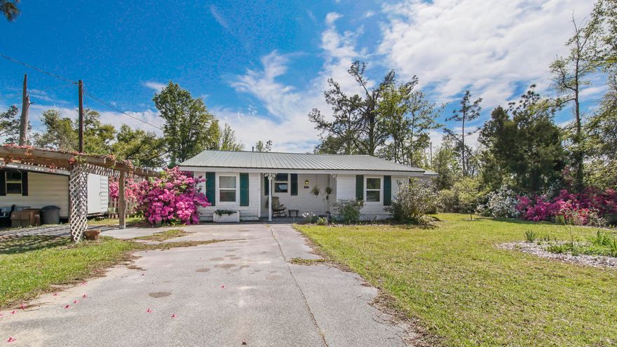 Well maintained home nestled in a quiet neighborhood. Home has many updates with some original features. The home has been updated with electrical, plumbing, metal roof in 2016, water heater in 2020, septic in 2019, well pump in 2018, pest control since 2013, new cabinets and counter-tops. Can pass a WDO Inspect. Entering the home there is an open floor plan with a bar at the kitchen, stove uses propane. Split bedrooms, with a large master. Professionally installed electrical to plug in a generator, that comes with the home. Mature azaleas surround the property along with many fruit trees. There are 2 sheds to use for storage and projects. Parking is under a carport and driveway use close to the home. This area is eligible for $0 down loans! Home is in fantastic shape! This area is Bay County unincorporated, no sewer / water bill. Come enjoy Country Living.