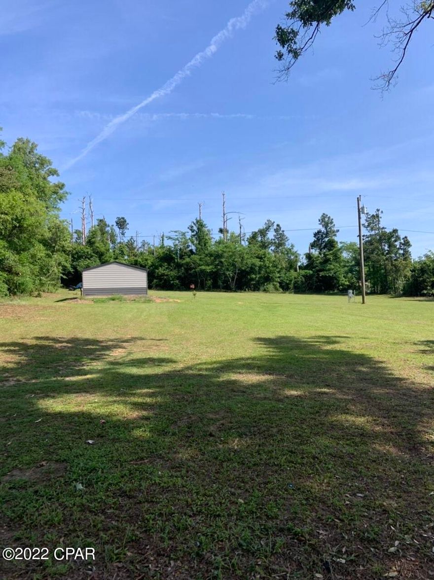 A beautiful lot in town but boast a sense of seclusion. Property is ready to build, city water and sewer available. Power already on property with  RV hookup and electricity hooked to shed. This unique property is close to Lake Seminole, Three Rivers State Park, Appalachicola River, schools and shopping. This is a must see to truly appreciate. 22x35 enclosed shed with roll up door on site to store your toys.