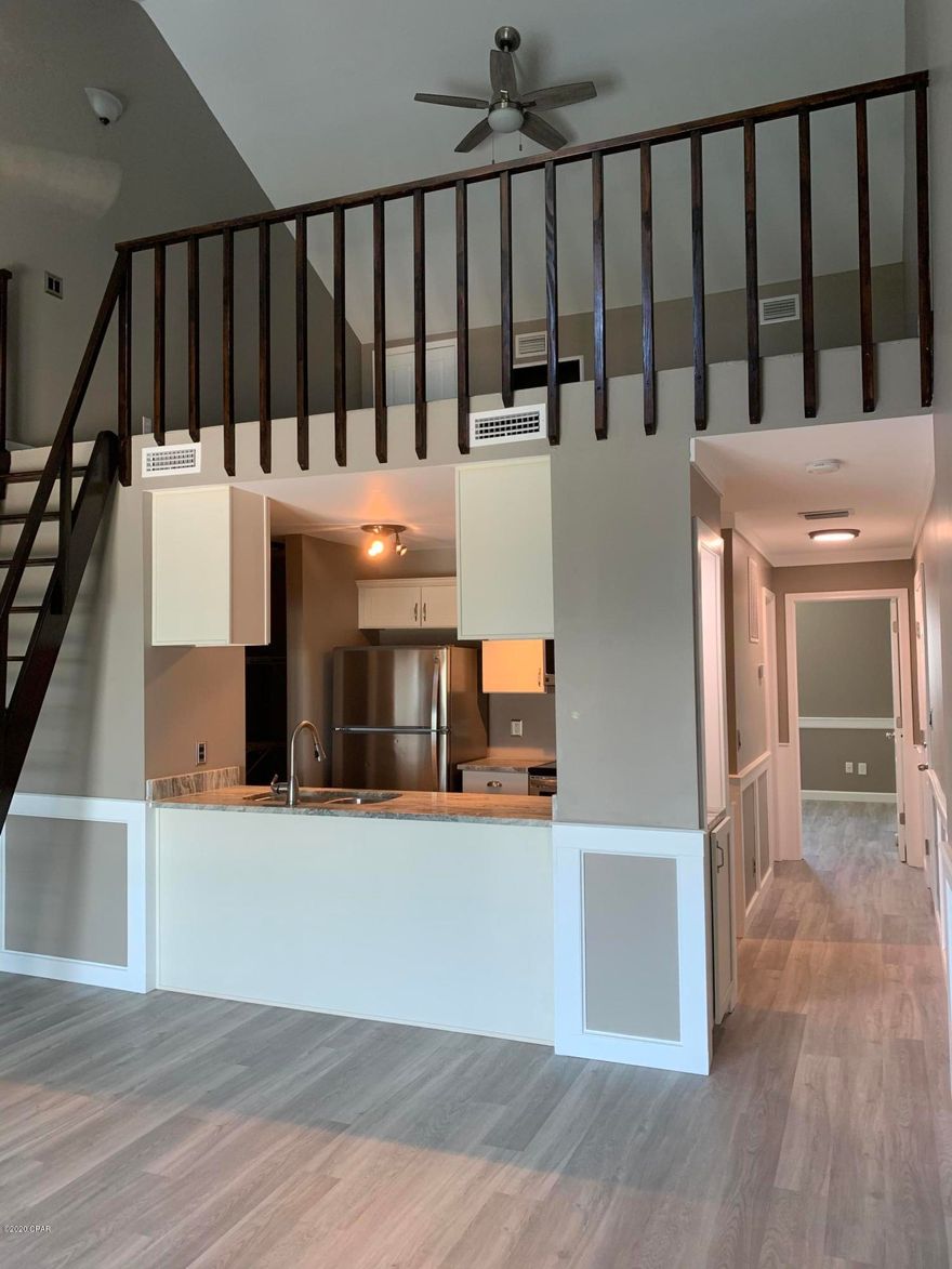 CURRENTLY UNDER CONTRACT, SELLER ACCEPTING BACKUP OFFERS. WOW! BEAUTIFUL WATERFRONT END UNIT W/ LOFT! New 2020 Construction/Rebuild from hurricane Michael.  Brand new AC, Hot Water Heater, Custom kitchen cabinets, granite countertops, vinyl plank flooring, custom molding & trim.  Stainless steel kitchen appliances, custom built pantry. Brand new washer & dryer!  Loft with custom built in & closet. This unit is a definite MUST SEE! Move in Ready!  Enjoy Beautiful sunsets from your spacious balcony (16x8) on Grand Lagoon! Across from Marina, seafood market, pontoon, jet ski & charter boats rentals,  Boat storage facilities close by. Walking distance to Beach and great restaurants! See Photos. Call for details.  All sizes approximate.