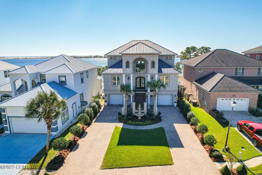 Under Contract, taking back up offers. This exquisite custom built luxury home is situated on the Santa Rosa Sound and offers spectacular views of the Gulf of Mexico. No expense was spared during construction. Built with reinforced Insulated Concrete Forms (ICF), all brick siding, impact resistance windows/doors, metal roof, and spray foam insulation. Entry way is adorned with double ornate iron doors into a large grand foyer with 25' ceilings and a gorgeous crystal chandelier. The foyer also features an oak paneled elevator. Through a columned archway you have a large formal living room with open concept kitchen and dining room separated by a breakfast bar. The large kitchen includes stainless steel appliances with convection microwave oven, gas cook top with large vent, and granite countertops throughout. The dining area has a crystal chandelier and features French doors that lead out the second level veranda. Back in the kitchen and through another archway is a short hallway that leads to a large walk-in pantry, half bathroom, and a laundry room with plenty of cabinets and a small sitting area. Rounding out the second level, on the east side of the home is where you'll find the Primary bedroom with walk-in closet. The ensuite bathroom features two separate vanities, Jacuzzi bathtub, TV, separate water closet, and floor to ceiling tile shower with dual shower heads. The bathrooms are fed by a tankless water heater. As you make your way back to the foyer and the grand staircase that leads to the third level, you'll be impressed by the superb craftsmanship of the curved wood and metal railing, the cantilever third floor, and a large arched picture window. The third story boasts a large family room with tray ceiling and storage room that could double as a built-in bunk room. Off one side of the family room is a second Primary bedroom with ensuite bathroom, tray ceiling and large walk-in closet. On the other side of the family room through an archway is the third bedroom, full bathroom, and linen closet. The balcony off the family room has incredible views of the Sound and Gulf of Mexico and generous outdoor living space. Hop in the elevator and take a ride down to the first-floor garage area. Walk out the garage French doors to the large backyard and down to your private beach area and boat dock. Equipped with water/electric, the dock has been newly upgraded and features solar tiki torch lights, an underwater fish light, and swim ladder. There's also a 16K boat lift with two new stainless-steel motors and remote-control unit, and a personal watercraft lift with a new GEM remote control unit.