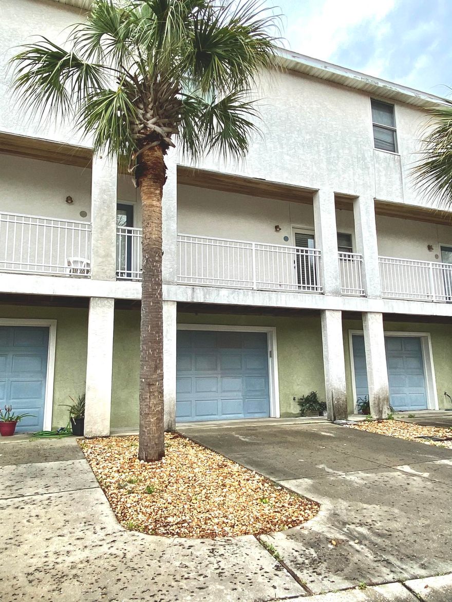 **Under Contract Taking Back up offers***

Want to own your very own vacation rental that's by the Lagoon and walking distance to the beach? Look no further! This  2 bedroom / 1.5 bath 3 story townhouse,  located right off Thomas Dr. in a gated community and is only one block from The World's Most Beautiful Beaches. Unit is right across from the community pool. Garage is on the 1st level and set up w/ a custom bar with newly painted interior walls and exterior walls.  This Beach Home offers a spacious living room on the 2nd level with a balcony that over looks the lagoon. Granite in kitchen with updated fixtures  Both Bedrooms are up on the 3rd level with full bath in between. House comes fully furnished with all beach decor for you or your next tenant.