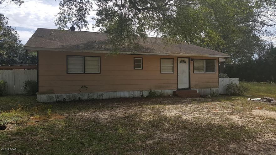 Lots of potential with this spacious 3/3 home on 1 acre. Home has kitchen, dining area, living room, master bedroom with master bath, additional bedroom has full bath, 3rd bedroom, hall bath. Entry can be used as addition room or office area. Mudroom with laundry. Fenced in back yard. 35x25 outbuilding. Paved road frontage. Needs work. Approx. 11 miles from amenities in Marianna. Priced to sell.