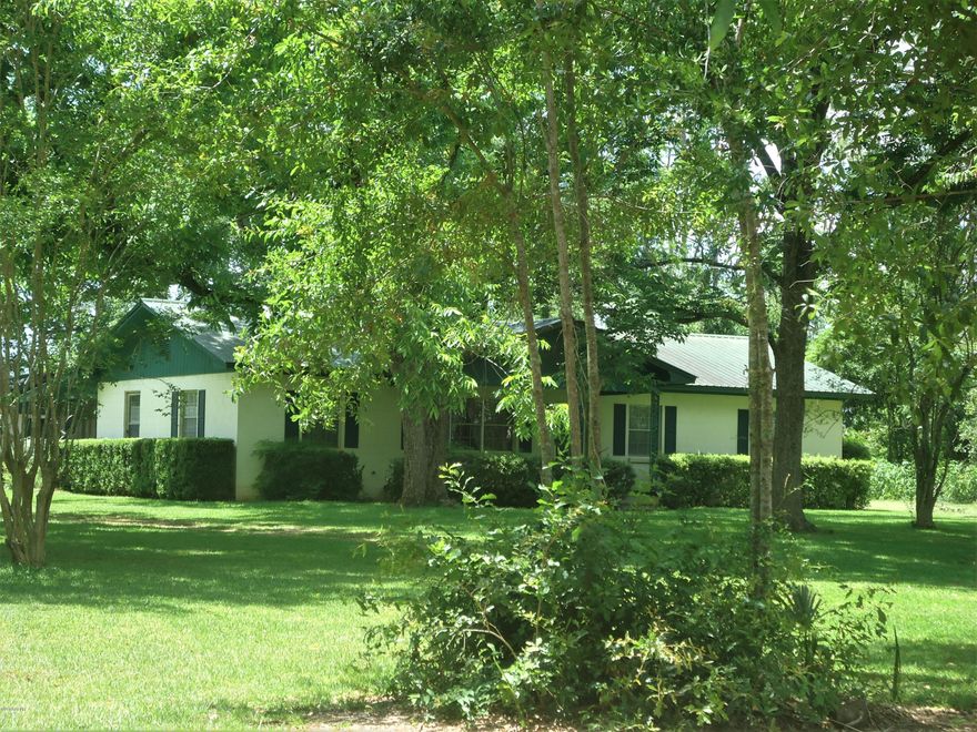 This is a rare opportunity to own 2 homes on approx 5 acres.  The main home is a 3 bedroom 2 bath block  home that has been well maintained. It has a beautiful yard and a view of Waddell's Mill Pond. There is an outdoor building that houses the washer and dryer with storage. The other home is mobile home that has an addition. It has 2 bedrooms and 2 baths with a large den addition and master area. Each home has its own septic and well.
