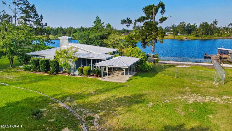 The UN-BEACH retreat! Look no further for your primary residence or weekend getaway than this cottage in the woods on a semi private lake. 

Masterfully crafted and designed by the original architect/owner, this home offers comfort, privacy and unparalleled amenities less than an hour from Panama City, FL or Dothan, AL. This custom-built cabin with 2 bedrooms/2baths is mostly cypress construction with hardwood floors, cypress siding, 9 ft ceilings and updated kitchen with granite countertops. Boasting a 12 ft. wide screened in porch that wraps around 2 sides of the house, (400 sq.ft. total), which is perfect for enjoying the view and breezes off the lake and catching that perfect afternoon nap. Situated on 2.5 acres of land with 312 ft on the private, spring fed lake, (Lake Highlands), fishing for trophy bass on this "electric motors only" lake or just relax on your 80 ft pier with a 12x12 covered boat house with a fish cleaning station. 

Fruit trees are abounding, including 4 orange and 1 lemon tree, pomegranate and persimmon, blueberries and two varieties of grape vines. The newer metal roof and sprinkler system reduces your outside maintenance and the 11x16 shed has enough space for your golf cart and gardening supplies. 

Your own private paradise awaits you! You owe it to yourself to look at this beauty, it will not last long!