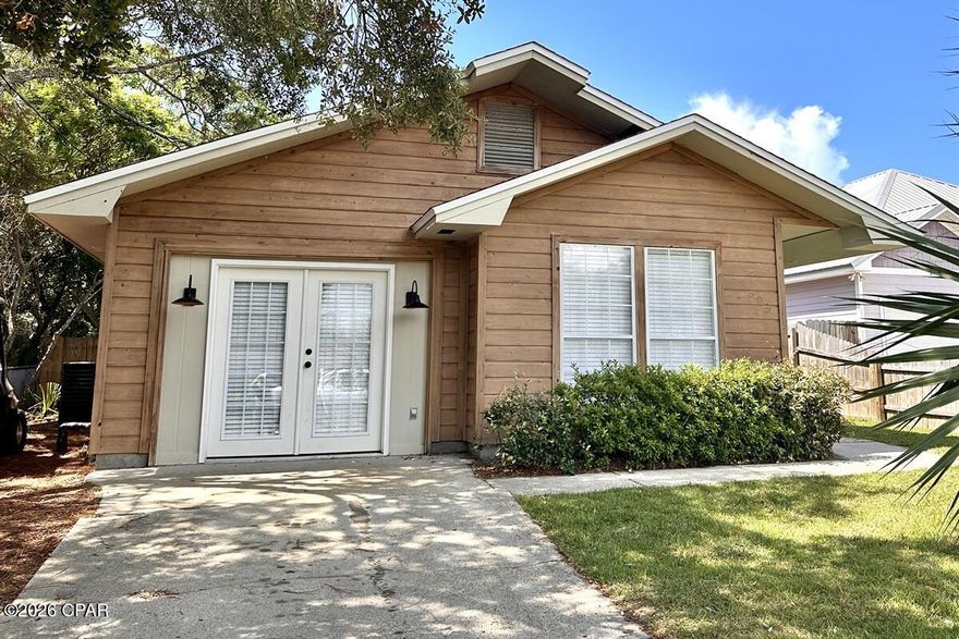 Completely renovated in 2023 and designed with today's buyer in mind, this turnkey 3 bedroom, 2 bath beach cottage offers the ideal blend of style, comfort, and income potential in the heart of Panama City Beach. With 1,295 square feet of thoughtfully updated living space, this property is already operating as a successful short-term rental and is perfectly suited as an investment property, second home, or full-time coastal retreat.

Step inside to a bright, open-concept floor plan featuring vaulted ceilings with exposed wood beams, recessed lighting, and luxury plank flooring throughout. The living area flows seamlessly into the dining space and kitchen, creating an inviting atmosphere for gathering and entertaining. The beautifully updated kitchen offers crisp white cabinetry, quartz countertops, open shelving, modern hardware, stainless appliances, and a large island overlooking the main living space.

The primary suite is a peaceful retreat with abundant natural light and a spa-inspired en suite bath featuring dual vanities, sleek fixtures, and a stunning tiled walk-in shower. Two additional guest bedrooms and a fully updated second bath provide comfortable accommodations for family and guests, maximizing rental flexibility.

Outdoor living is where this home truly shines. A screened-in patio extends the living space and offers the perfect spot for morning coffee or evening cocktails. The fully fenced backyard is private and spacious, complete with a fire pit gathering area and ambient string lighting that creates an inviting coastal setting for guests. An irrigation system on well water helps maintain the lush lawn while keeping utility costs down.

The exterior showcases charming coastal cottage appeal with warm wood siding and thoughtful architectural details that set it apart. The manageable lot size makes ownership easy while still offering ample outdoor enjoyment.

Located just minutes from the white sandy beaches and only about 10 minutes to Rosemary Beach, this property offers exceptional short-term rental appeal in a highly desirable area near dining, shopping, and entertainment. With recent renovations, modern finishes, and an established rental presence, this is a true turnkey opportunity.

Whether you are looking to expand your investment portfolio or secure your own beach getaway that can generate income when not in use, 21309 Caribbean Lane delivers both lifestyle and strong income potential in one beautifully updated package.